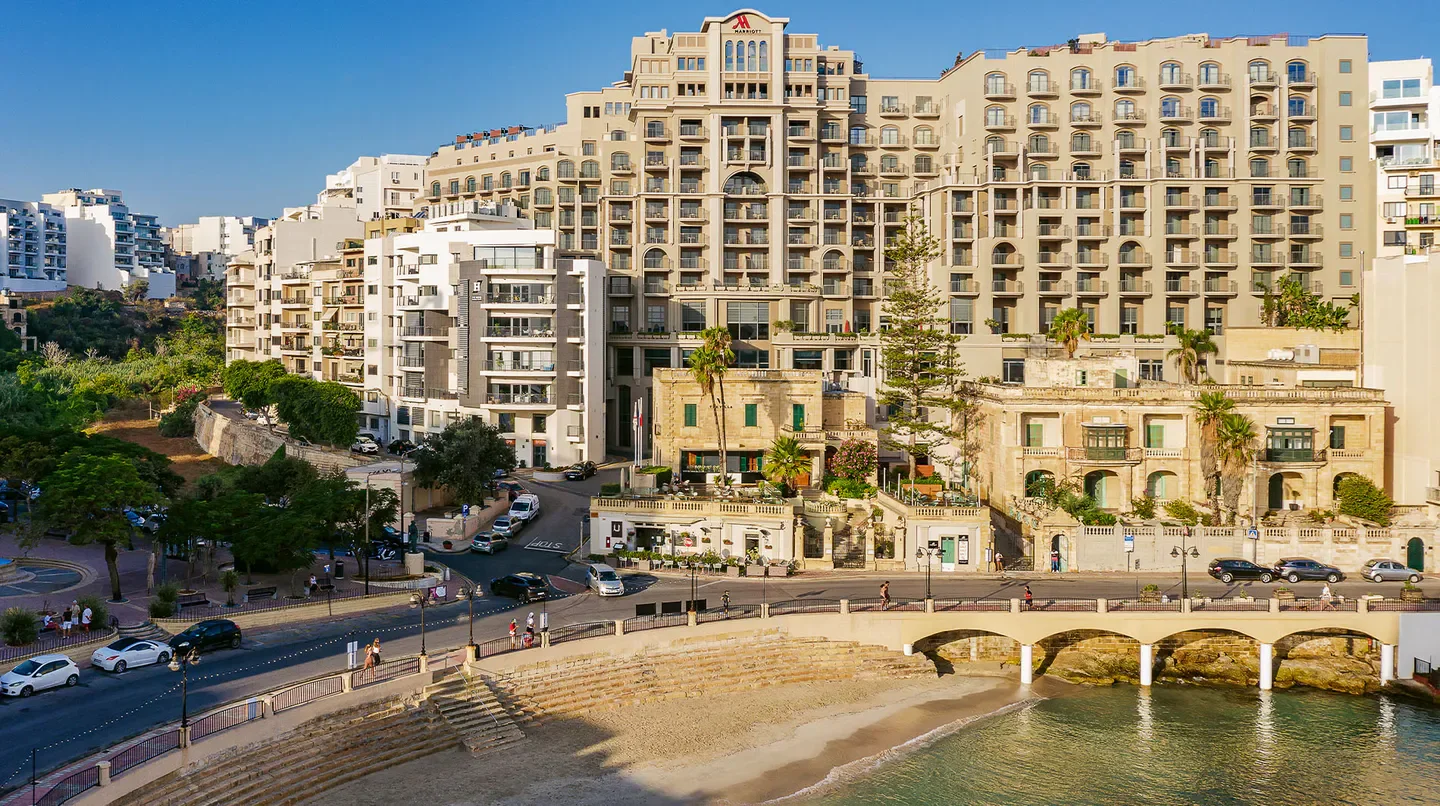 Coastal view of the Malta Marriott Hotel & Spa in Malta with a beautiful beach.