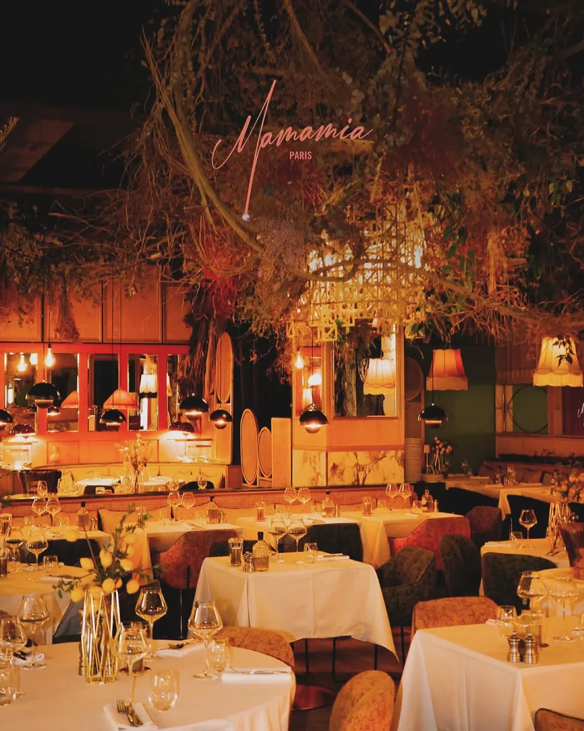 Cozy interior of Mamamia restaurant in Paris, featuring elegant table settings and unique floral decor for a memorable dining experience.