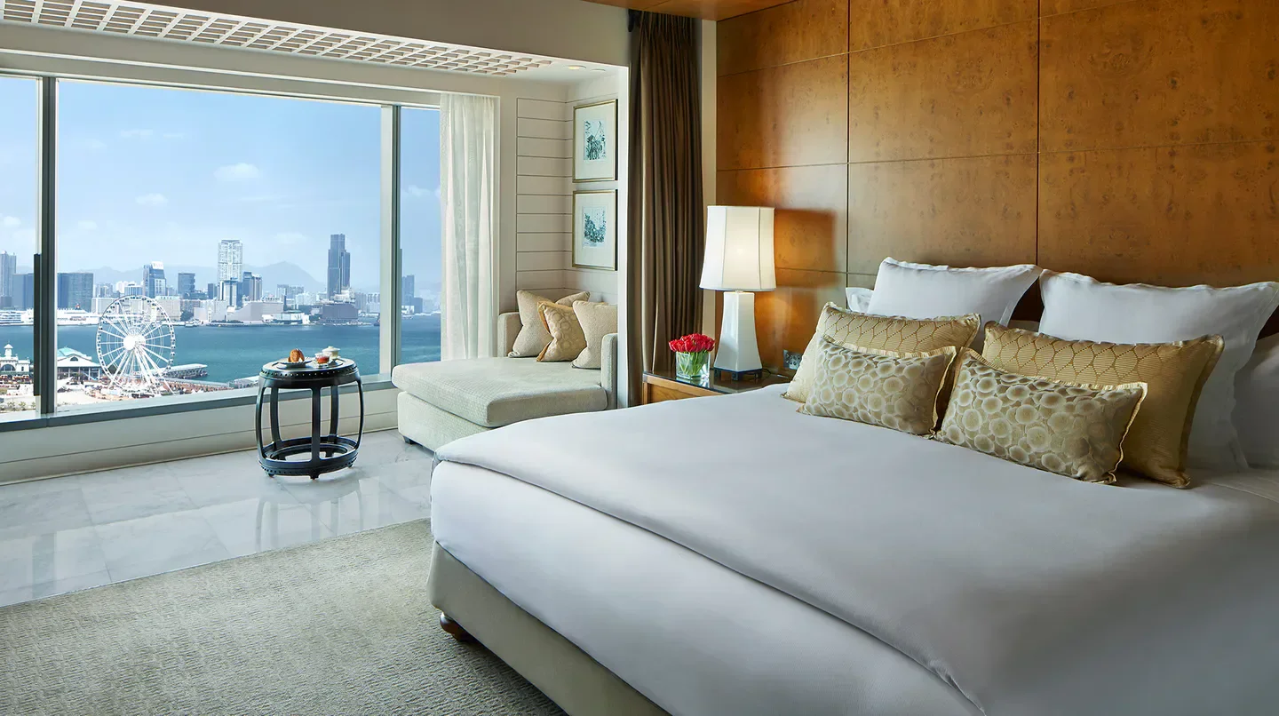 Bedroom view at Mandarin Oriental, Hong Kong, overlooking Hong Kong's skyline and harbor.