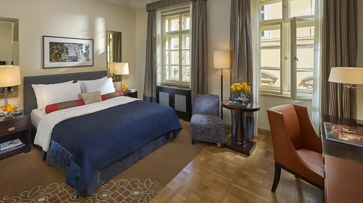 Cozy bedroom at the Mandarin Oriental, Prague hotel, featuring a desk and window.