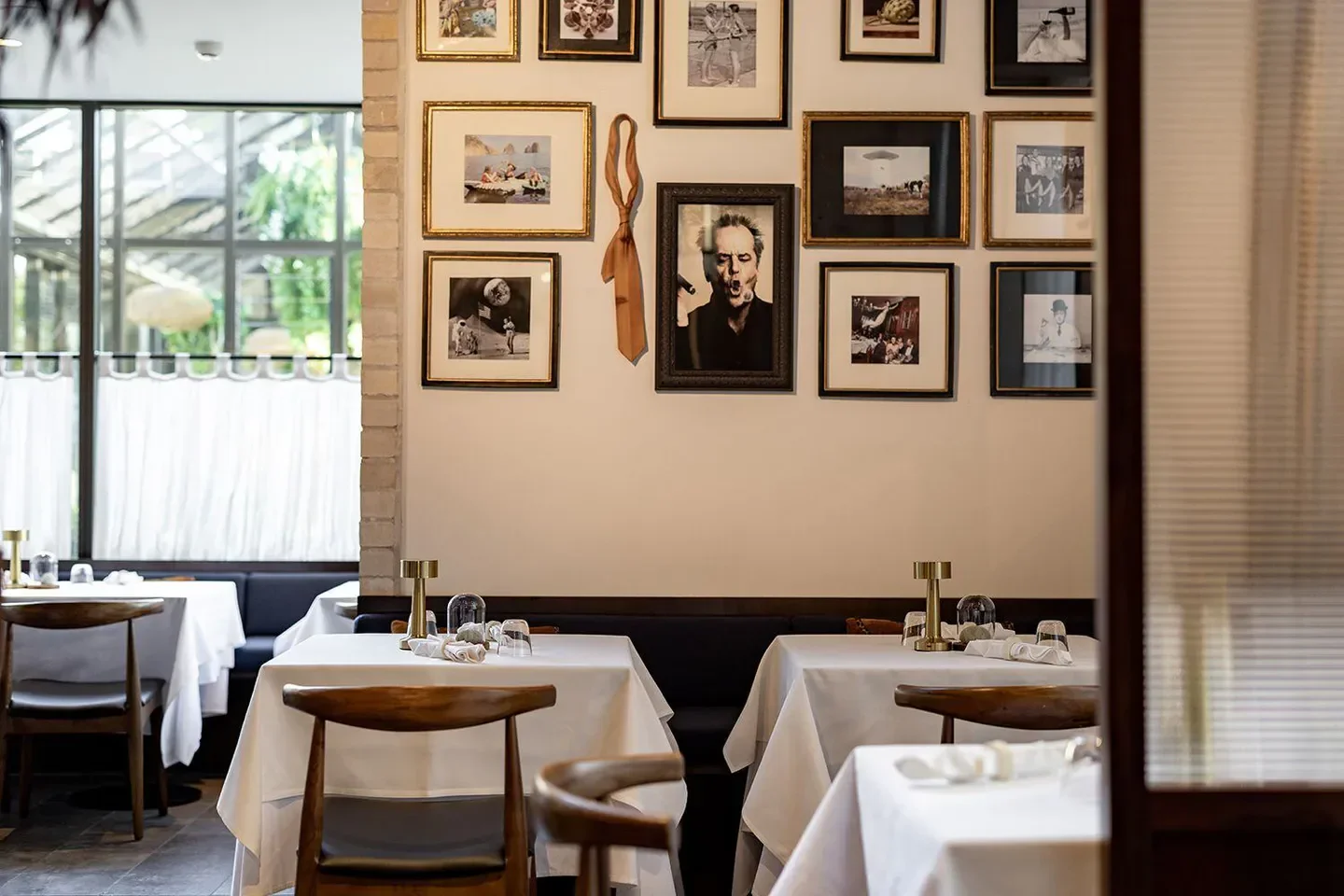 Interior of Manzo restaurant in Auckland, with tables and art on the walls.