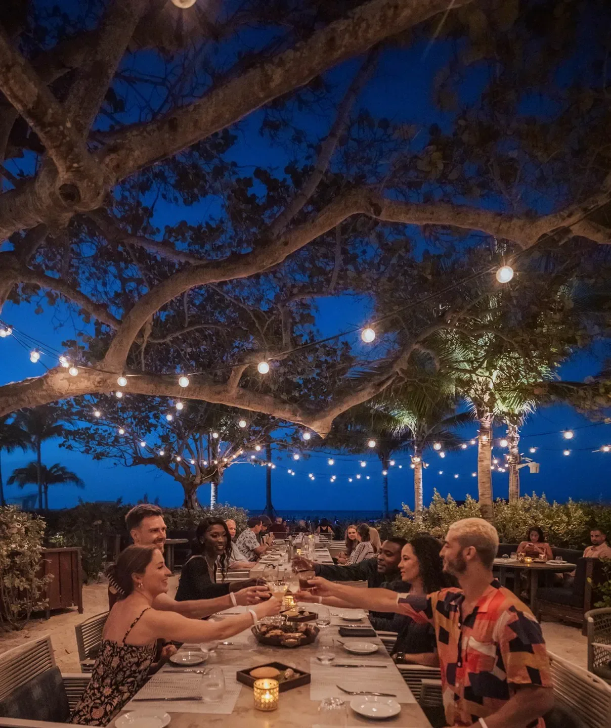 Outdoor dining at Marcus at Baha Mar Fish Chop House in Nassau with string lights.
