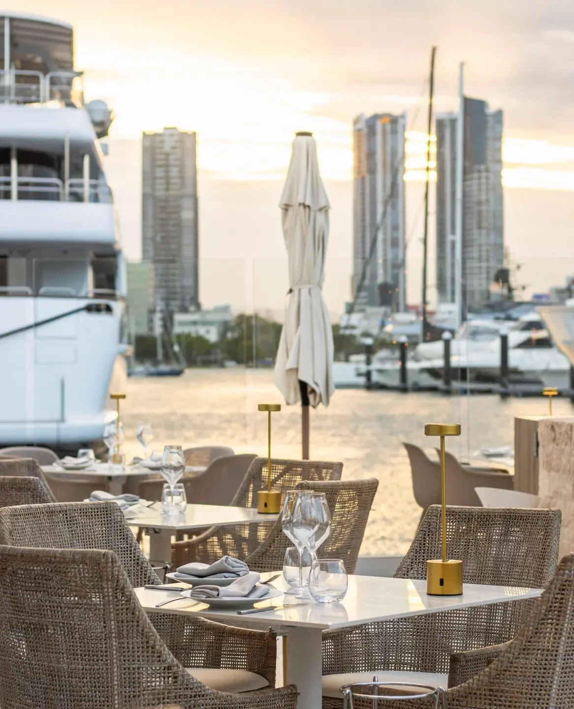 Outdoor dining at MĀRE by La Luna Beach Club in Gold Coast with waterfront views.
