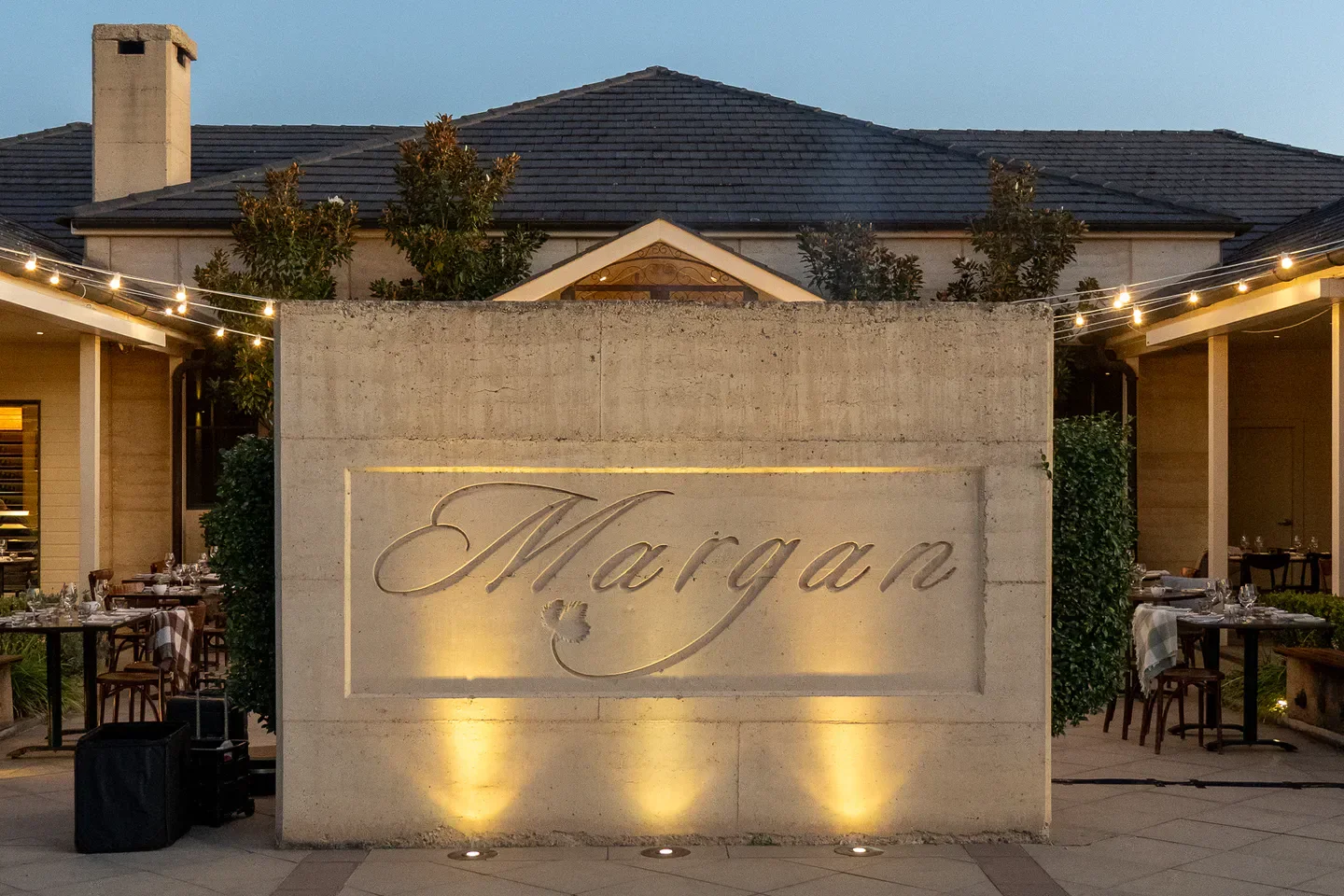 Entrance sign at Margan Restaurant & Winery in the Hunter Valley, illuminated at dusk.