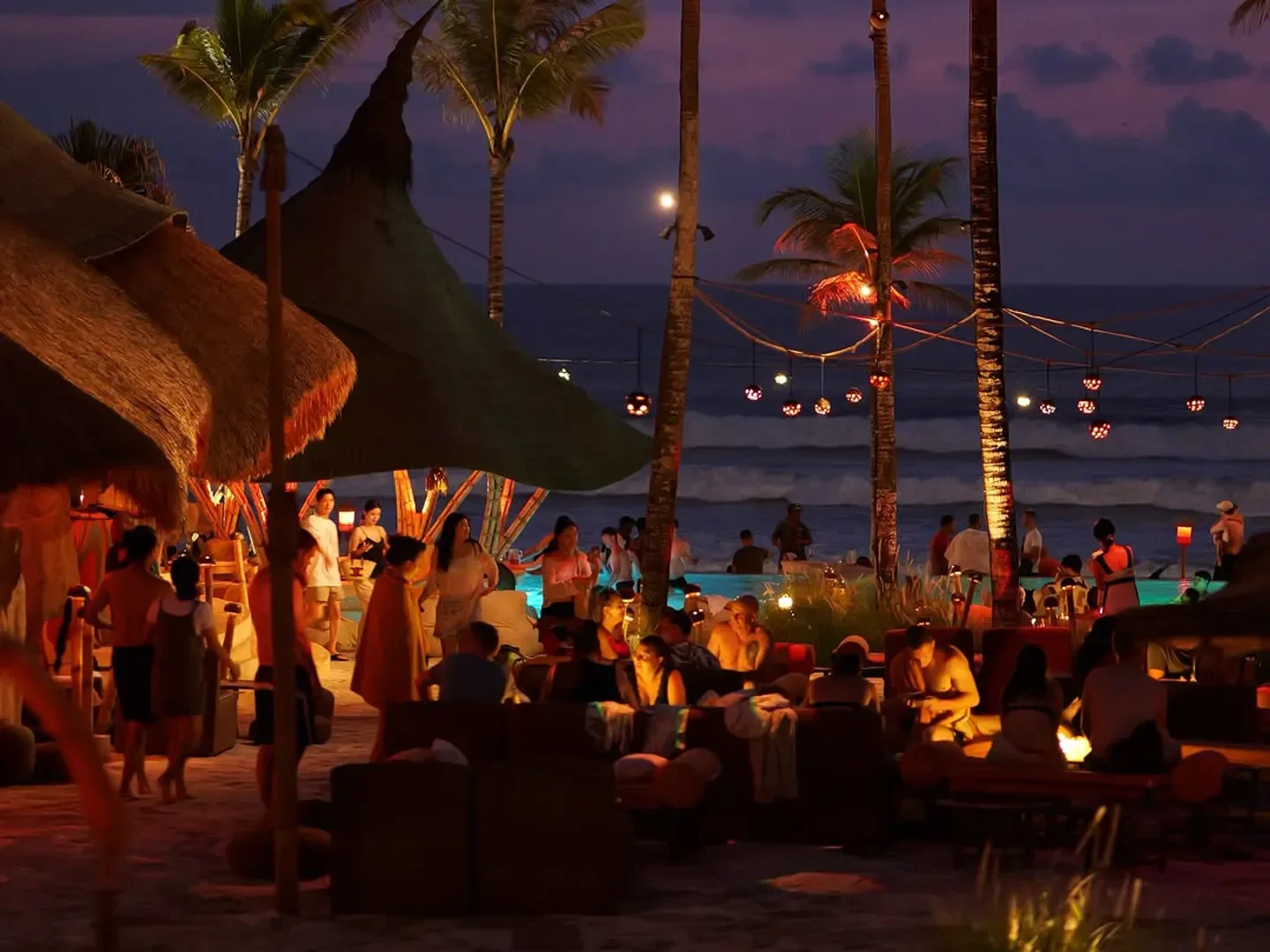 Mari Beach Club in Bali at night, beachfront dining with ocean views.