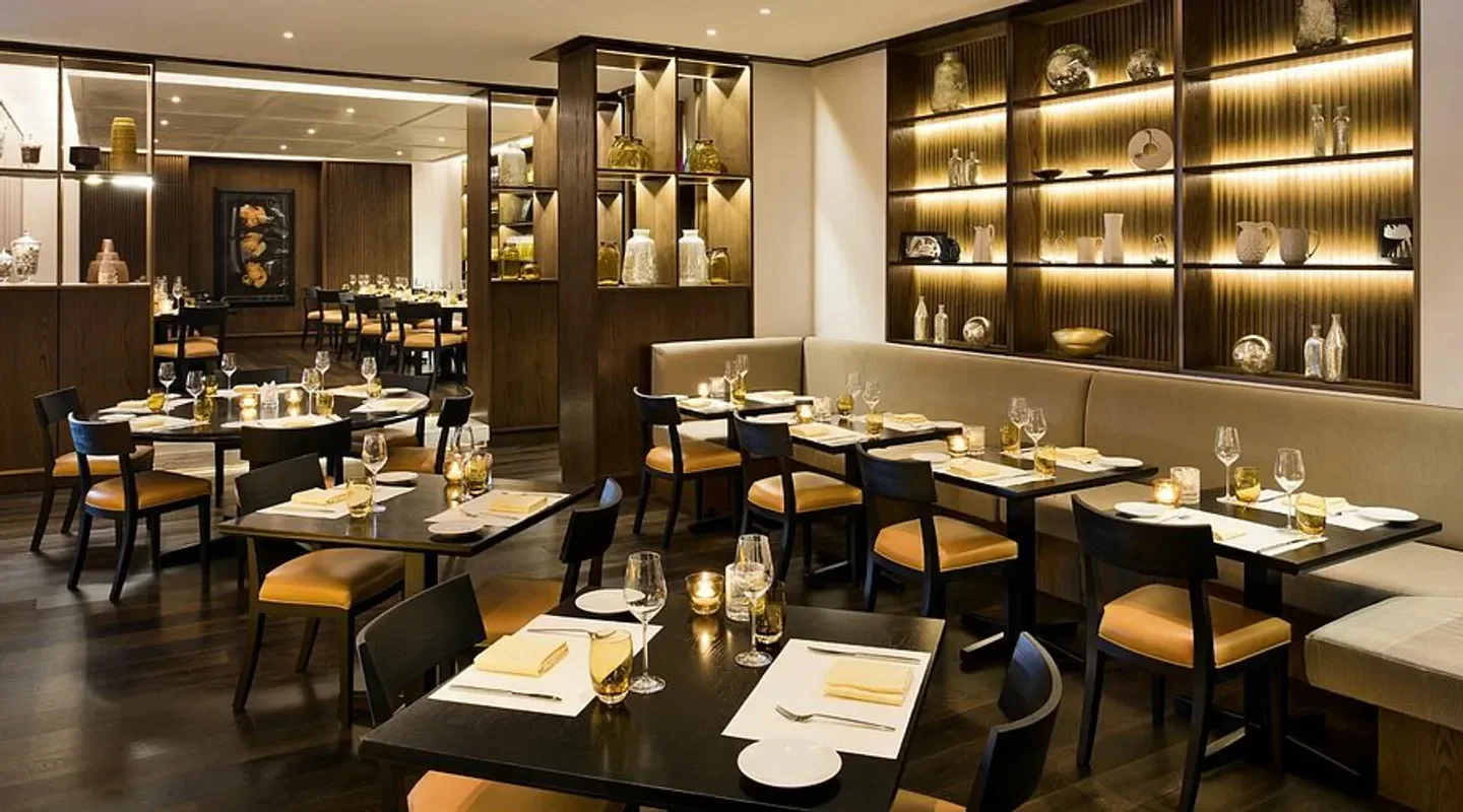 Interior dining at Market by Jean-Georges in Doha, featuring elegant table settings.