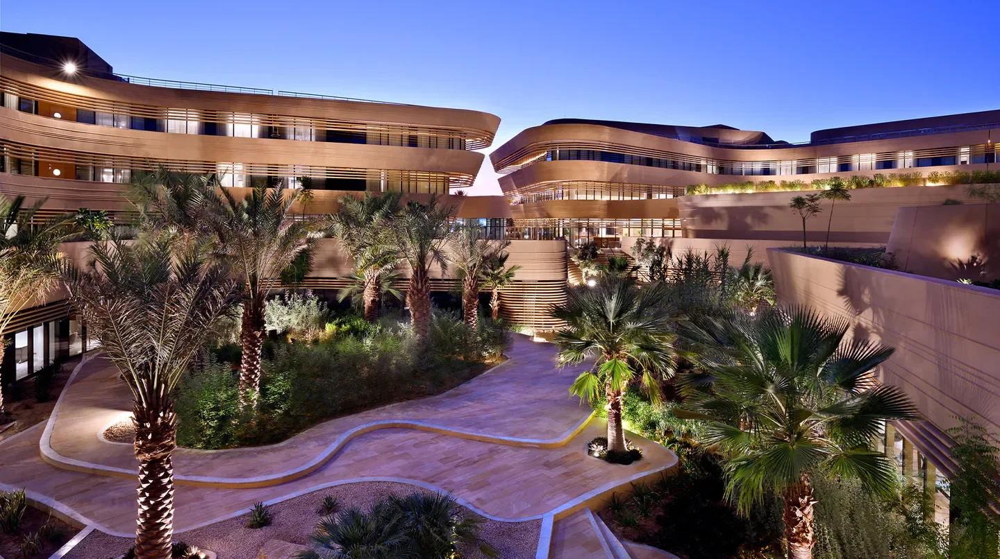 Exterior view of the Marriott Riyadh Diplomatic Quarter hotel in Riyadh, featuring palm trees and architecture.