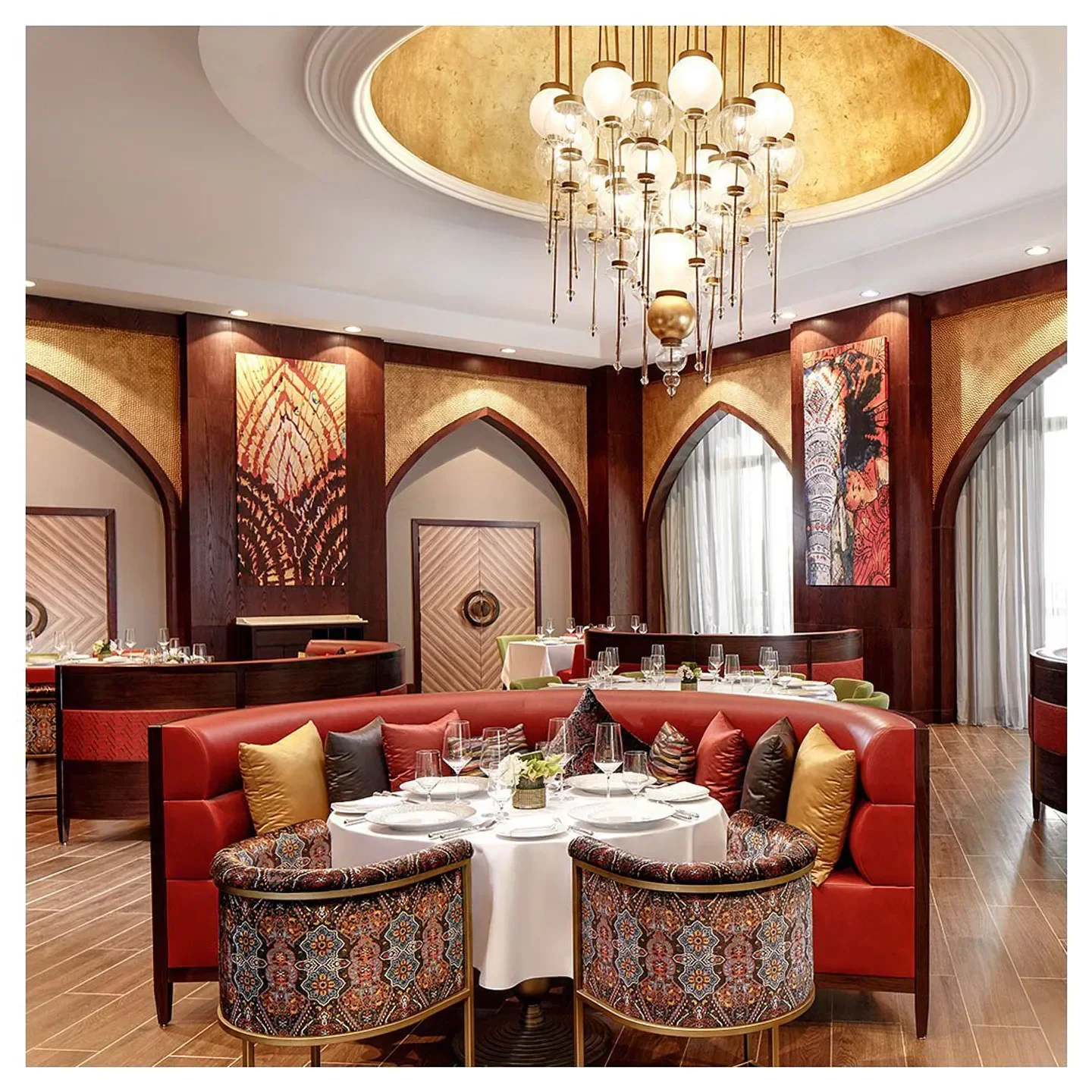 Interior of Martabaan restaurant in Abu Dhabi featuring elegant seating and a beautiful chandelier.