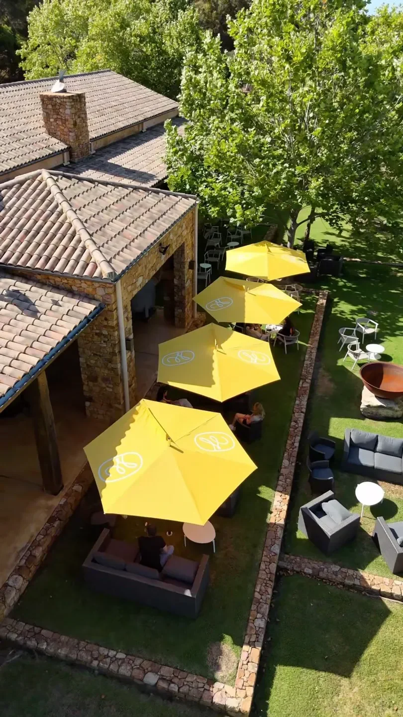 Outdoor seating at Masseria by Cherubino restaurant in Margaret River with yellow umbrellas