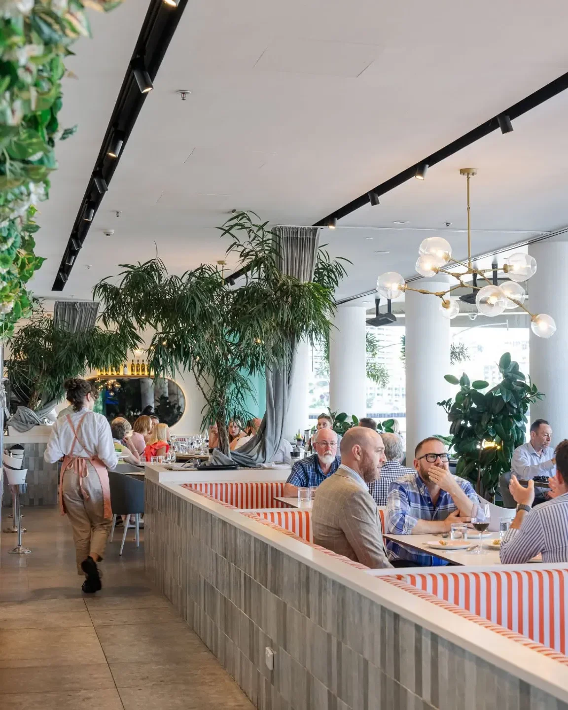 Inside Massimo Restaurant & Bar in Brisbane, showcasing stylish decor and diners enjoying their meals.