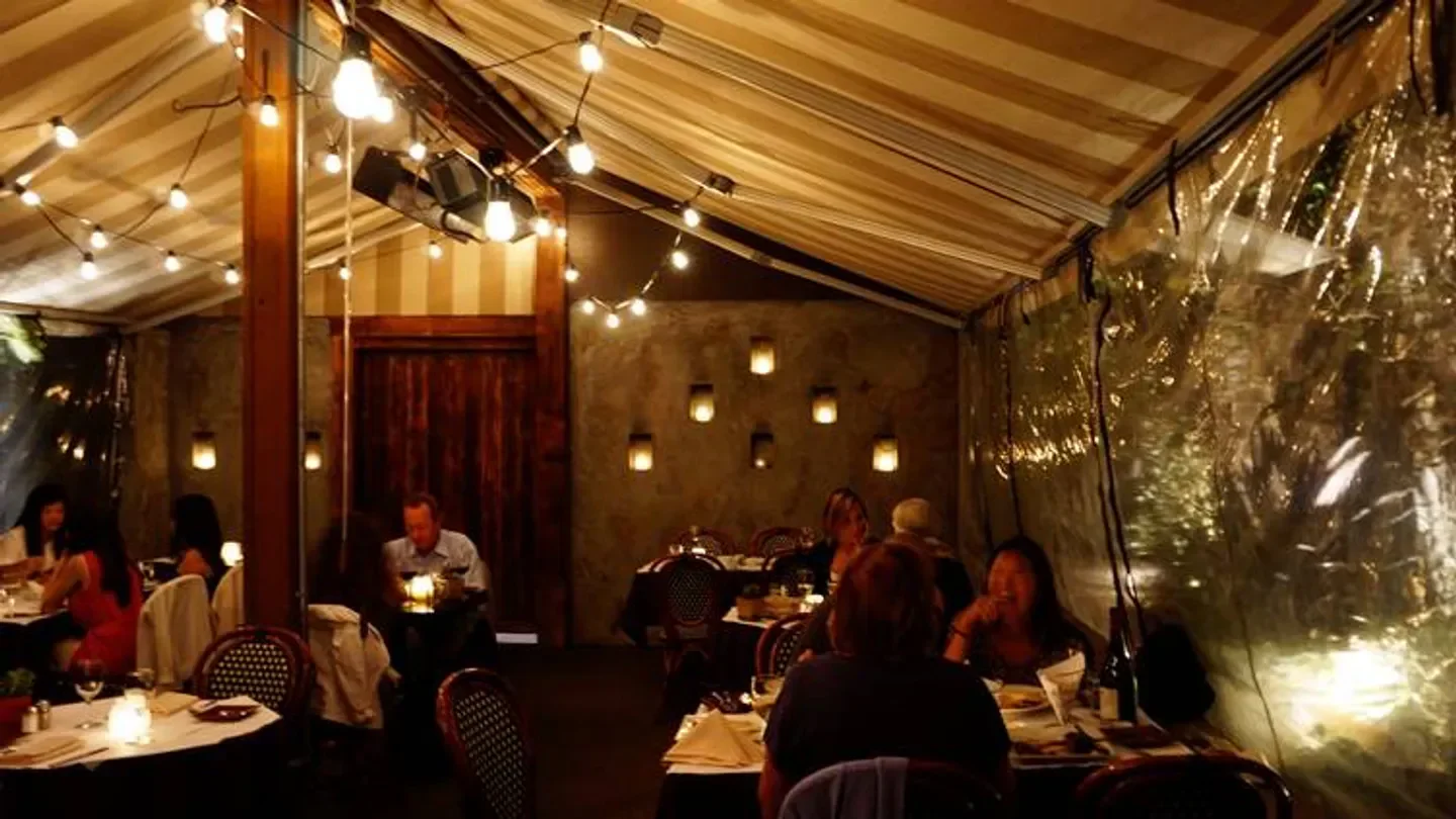Cozy dining area at Mathilde French Bistro in San Francisco with string lights.