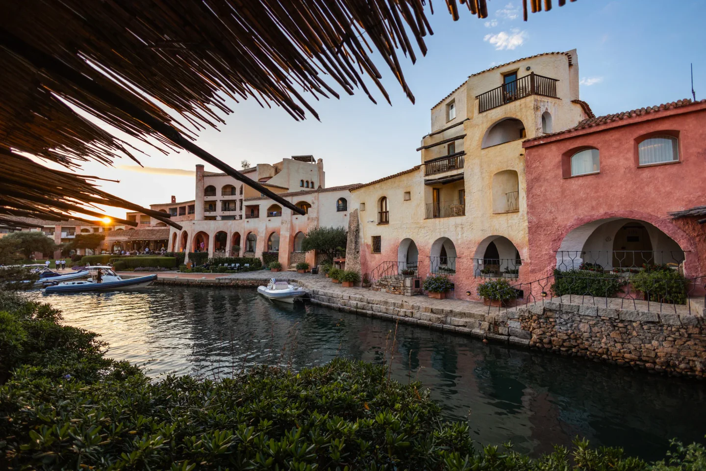 Waterfront view of Matsuhisa at Cala di Volpe restaurant in Porto Cervo with boats and sunset sky