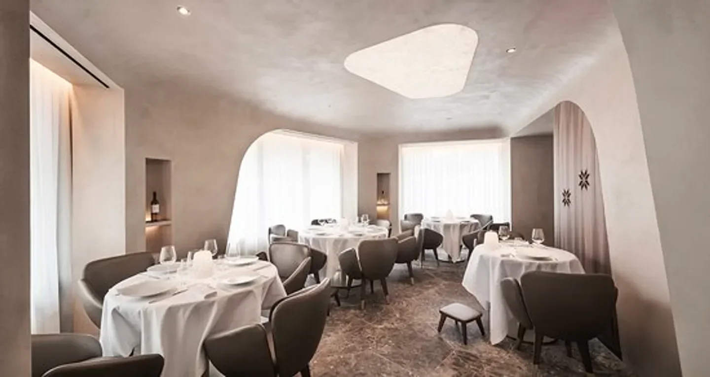 Elegant interior of Mavrommatis restaurant in Paris, with tables set for dining.