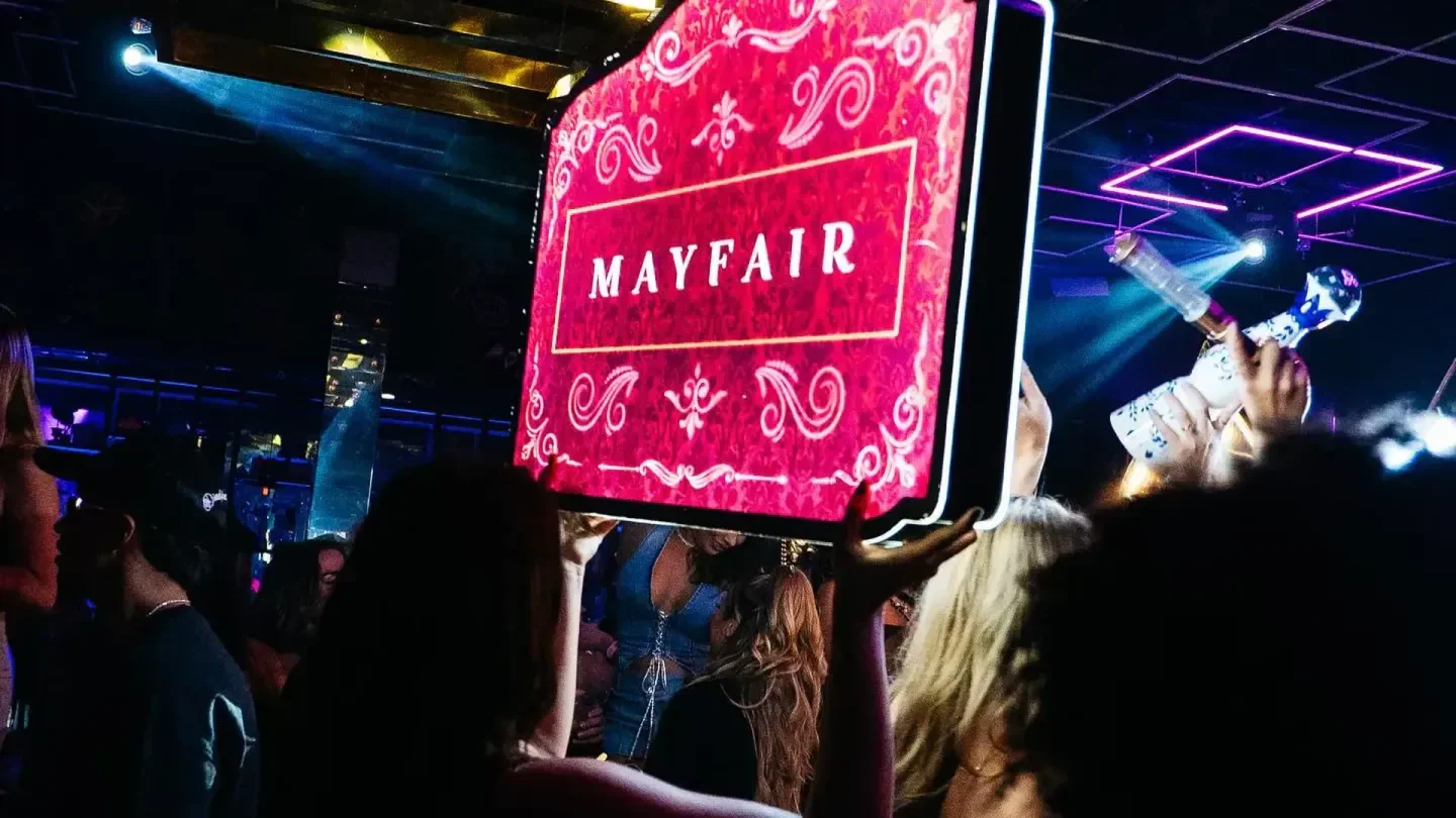 Mayfair Austin nightclub sign held high at a party in Austin, Texas.
