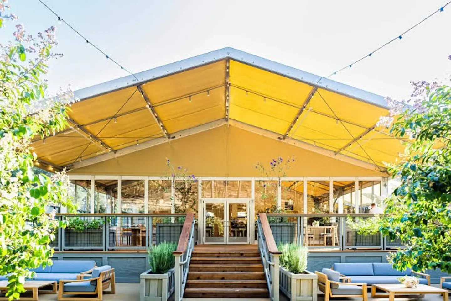 Exterior of Meadowood Spa in Napa Valley with inviting outdoor seating and architecture.