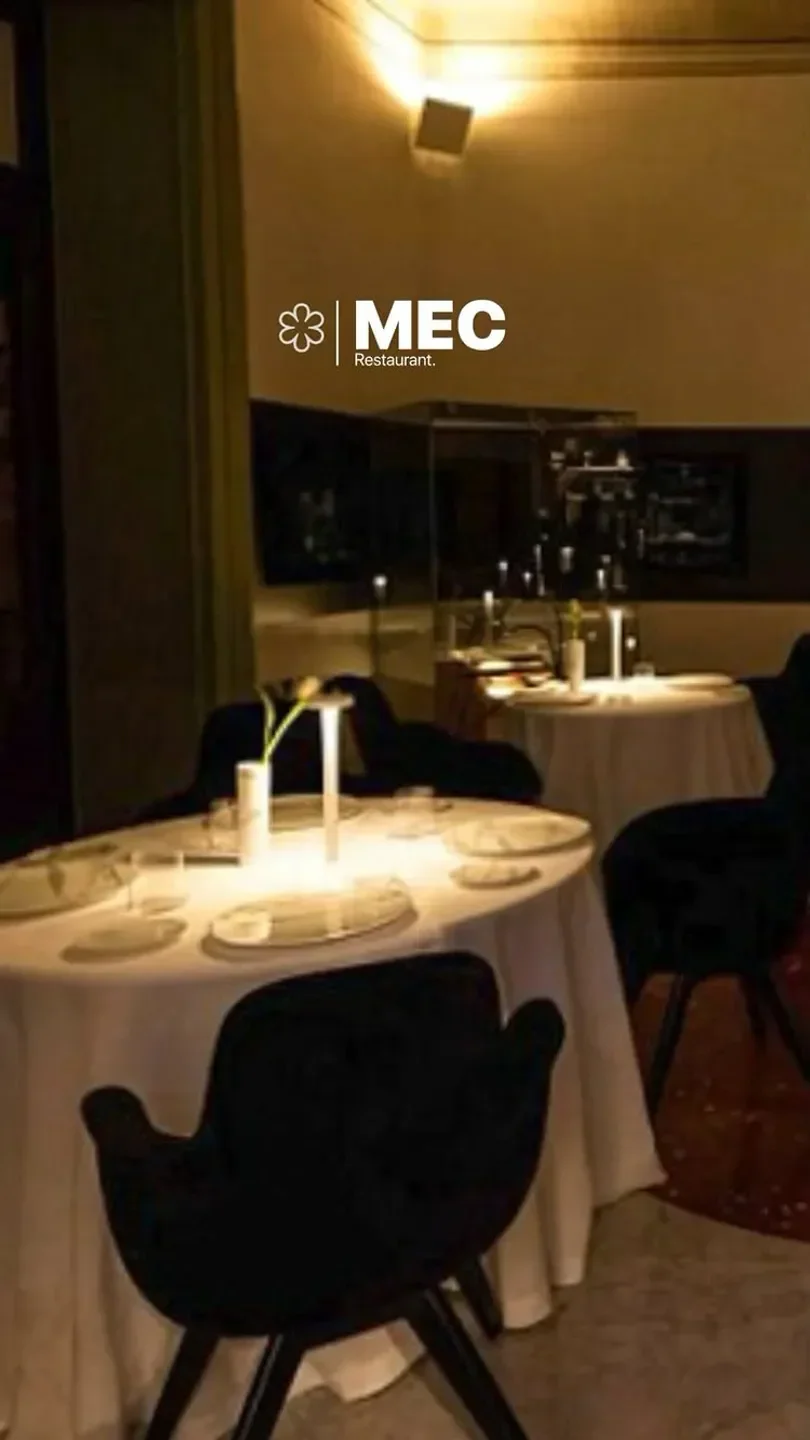 Elegant dining at Mec Restaurant in Sicily, featuring soft lighting and a modern interior.