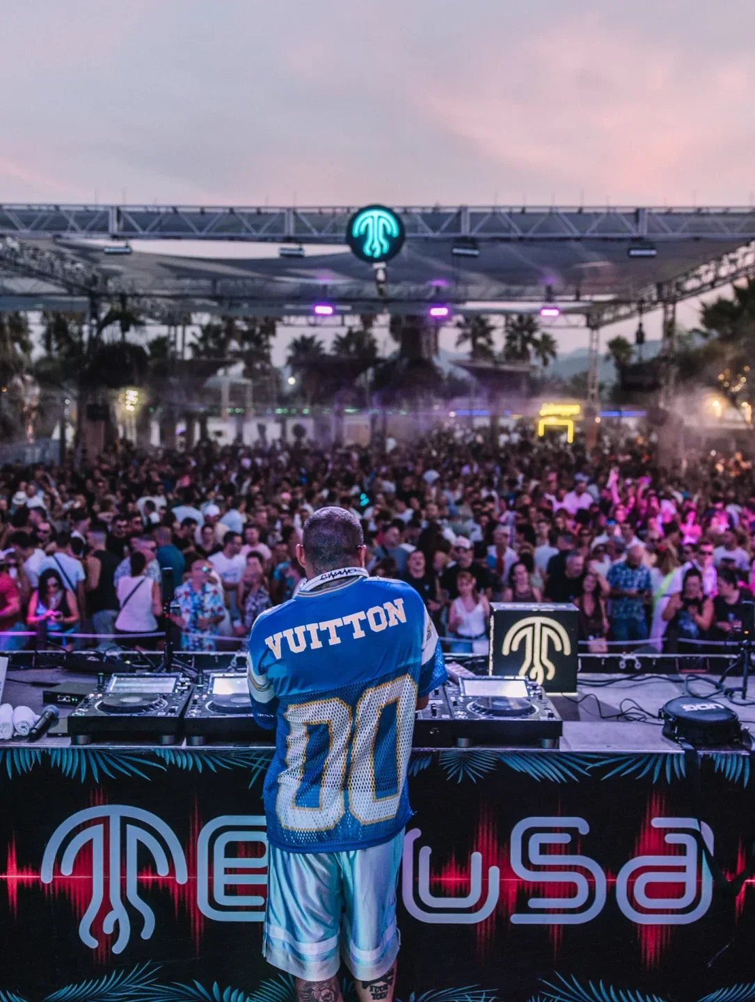 DJ at Medusa Beach Club in Valencia, performing for a large crowd at sunset