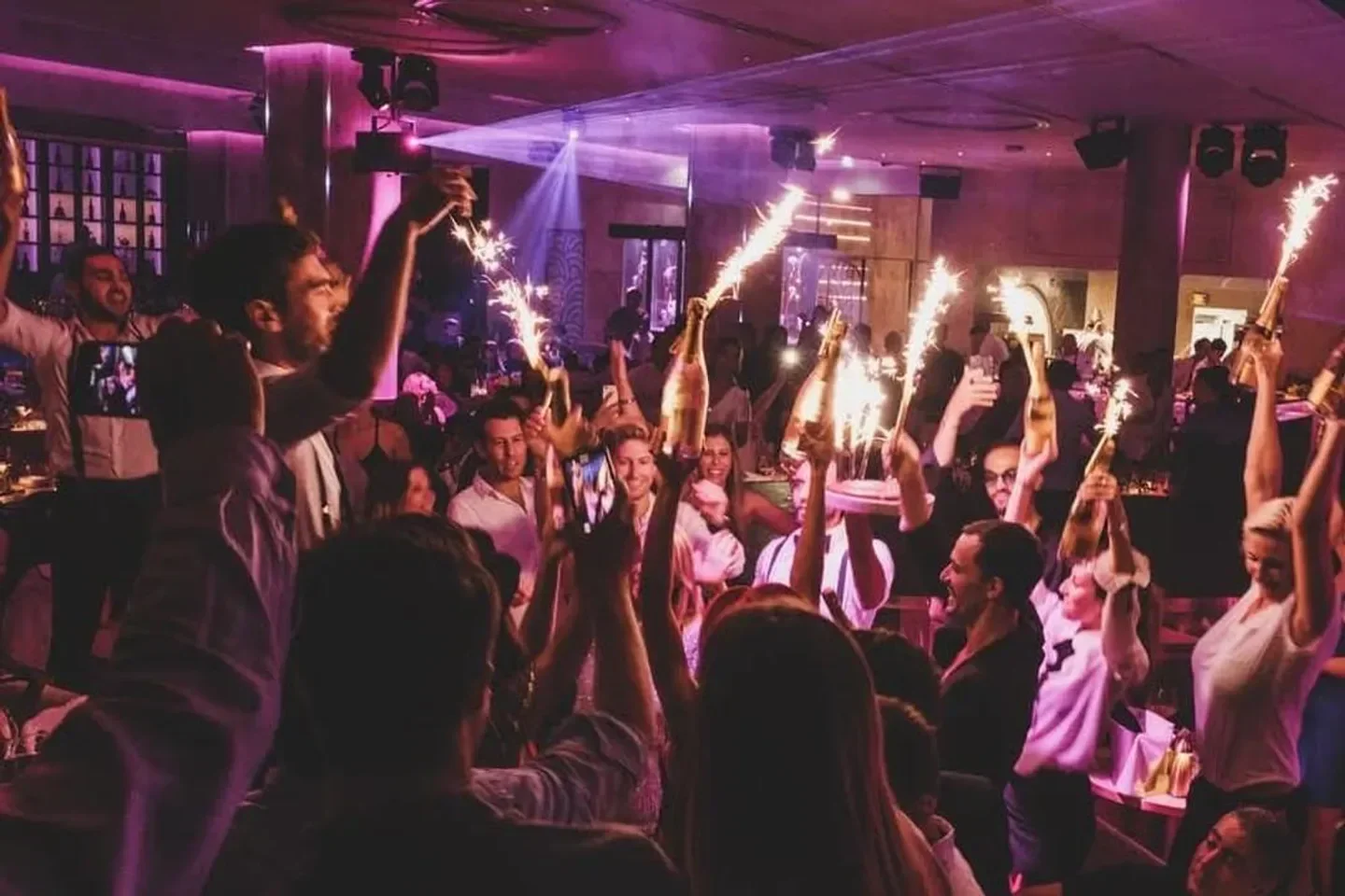 Celebratory atmosphere at Medusa restaurant in Cannes, with sparklers and champagne.