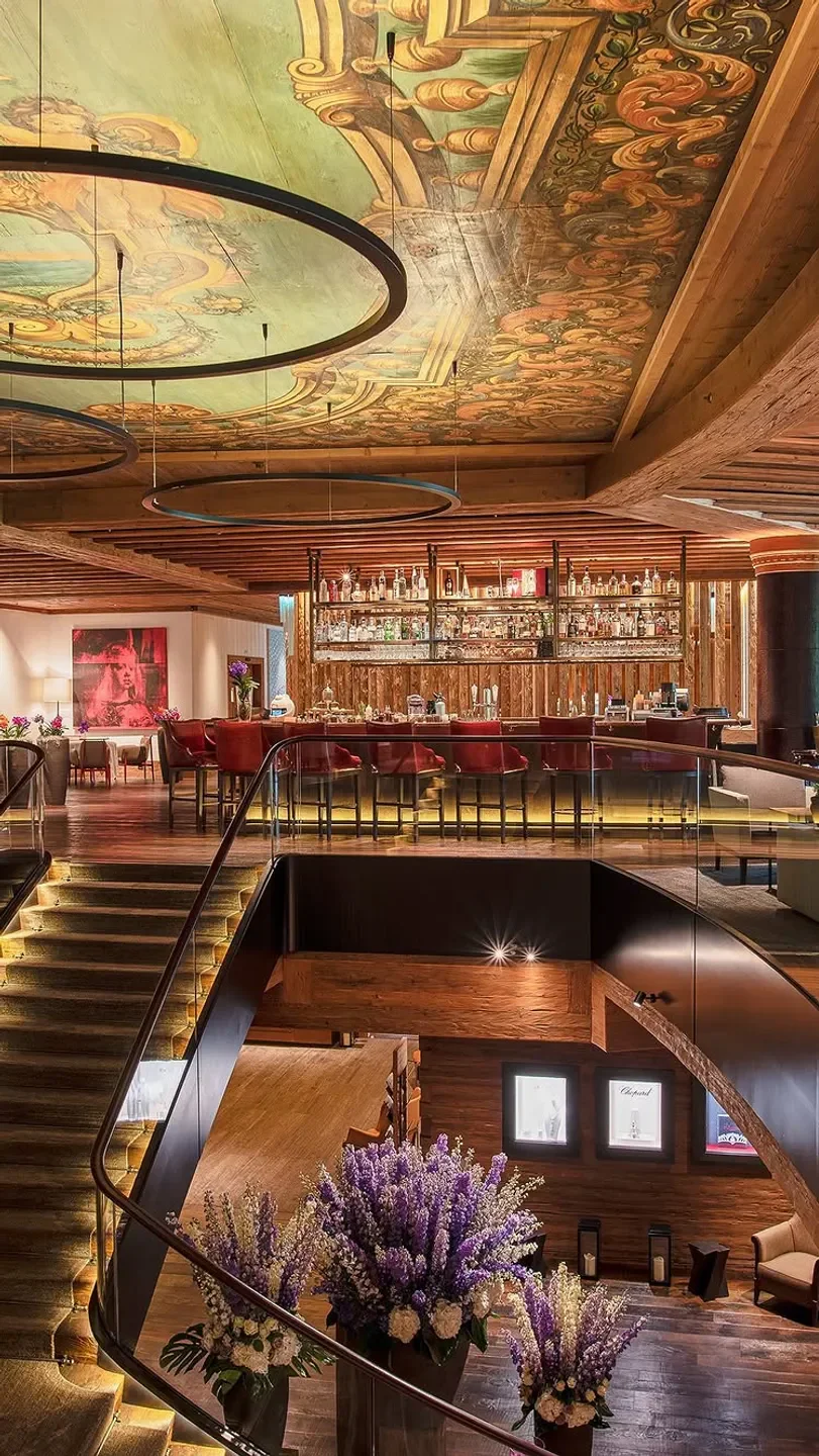 Stunning interior view of MEGU Gstaad with a bar and decorated ceiling