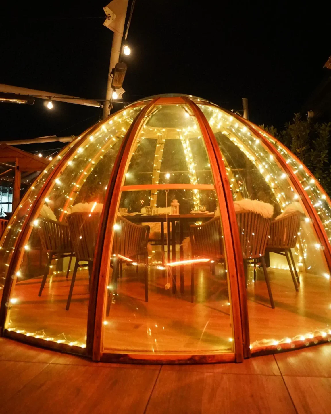 Cozy, fairy-lit igloo dining pod at Mercer Roof Terrace, London, perfect for intimate rooftop evenings.