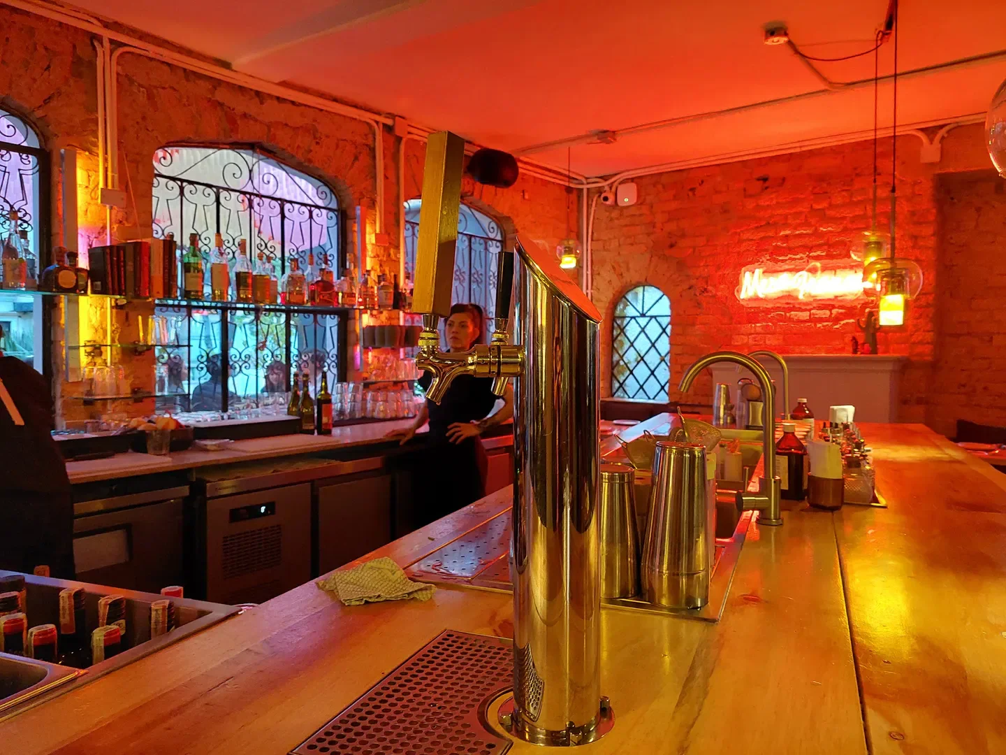 Interior of Mesa Franca restaurant in Bogota, featuring a stylish bar with warm lighting.