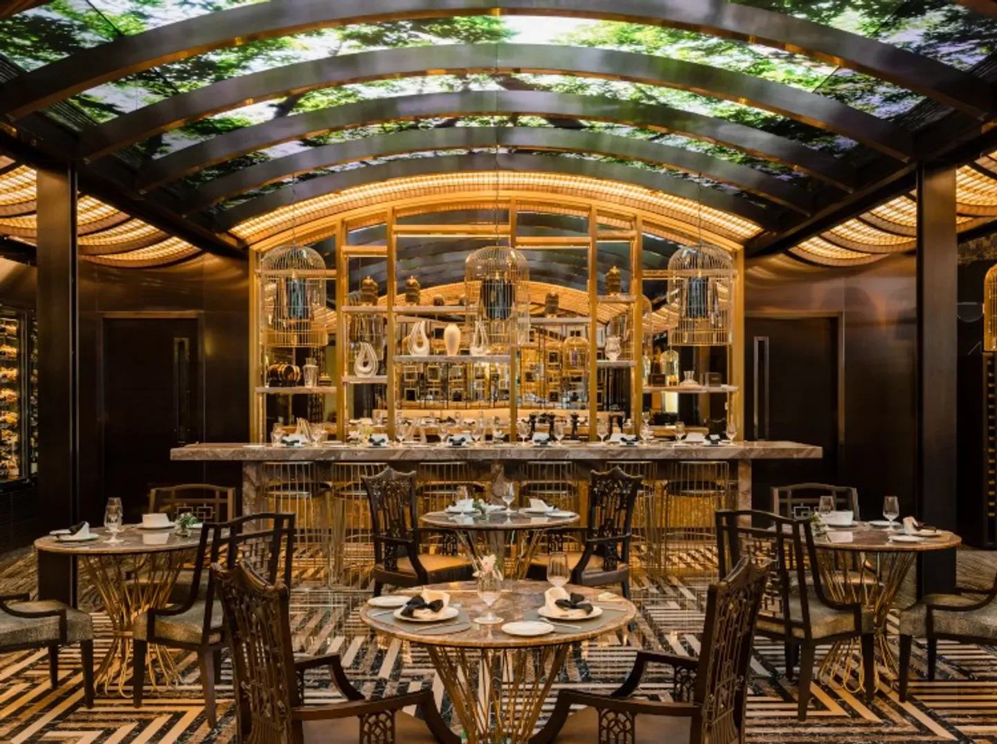Elegant interior of Mesa restaurant in Macau, showcasing unique birdcage decor and dining tables.