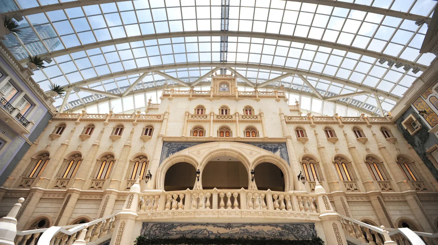 Stunning architecture at MGM MACAU hotel in Macau, showcasing glass ceiling and ornate design.