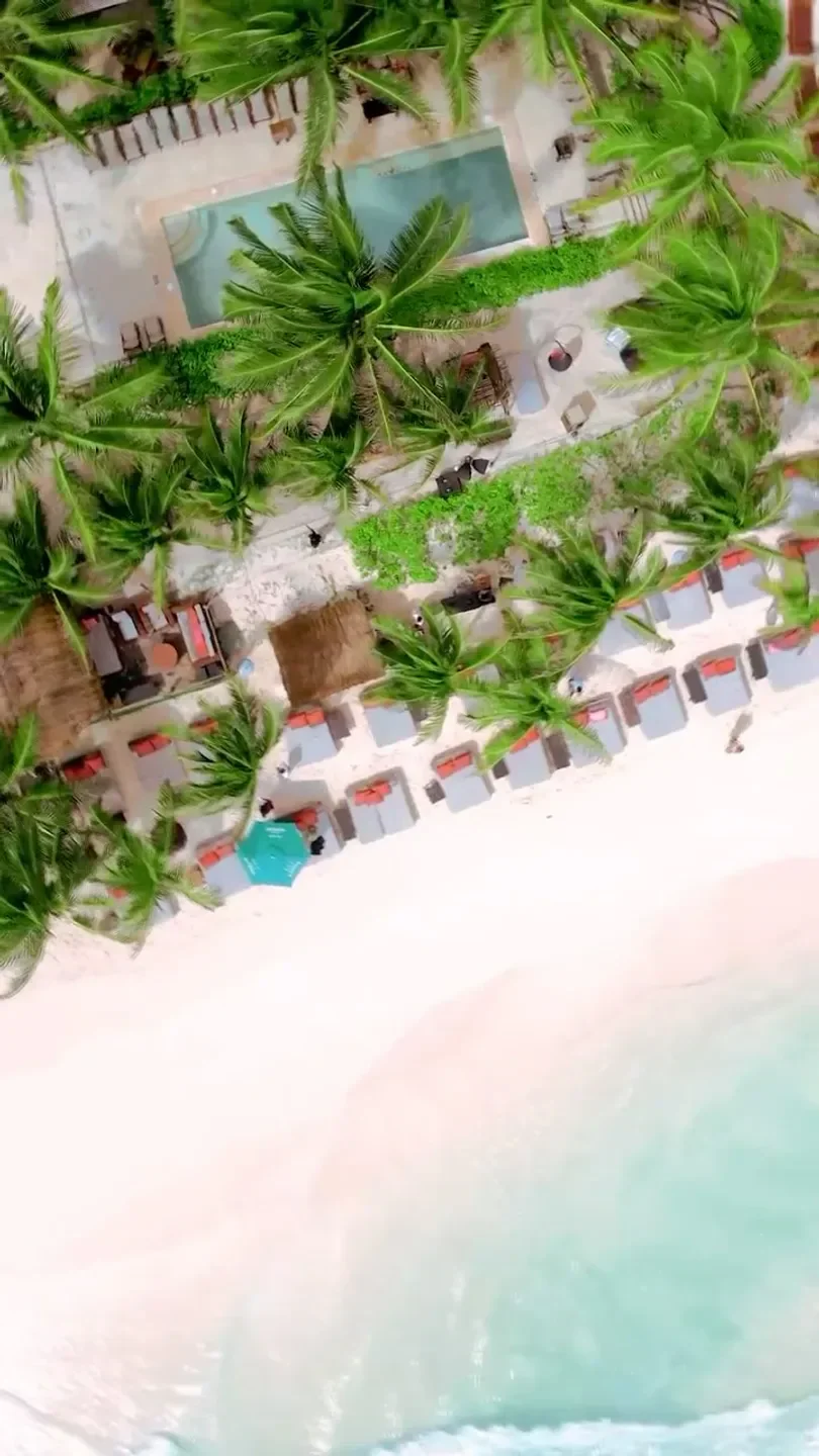 Aerial view of Mia restaurant in Tulum, showcasing beachside cabanas and pool.