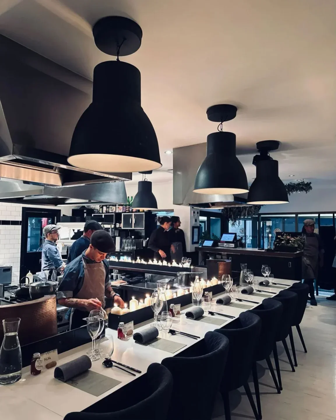 Interior of Miki's Open Kitchen in Margaret River, with chefs and elegant dining setup.
