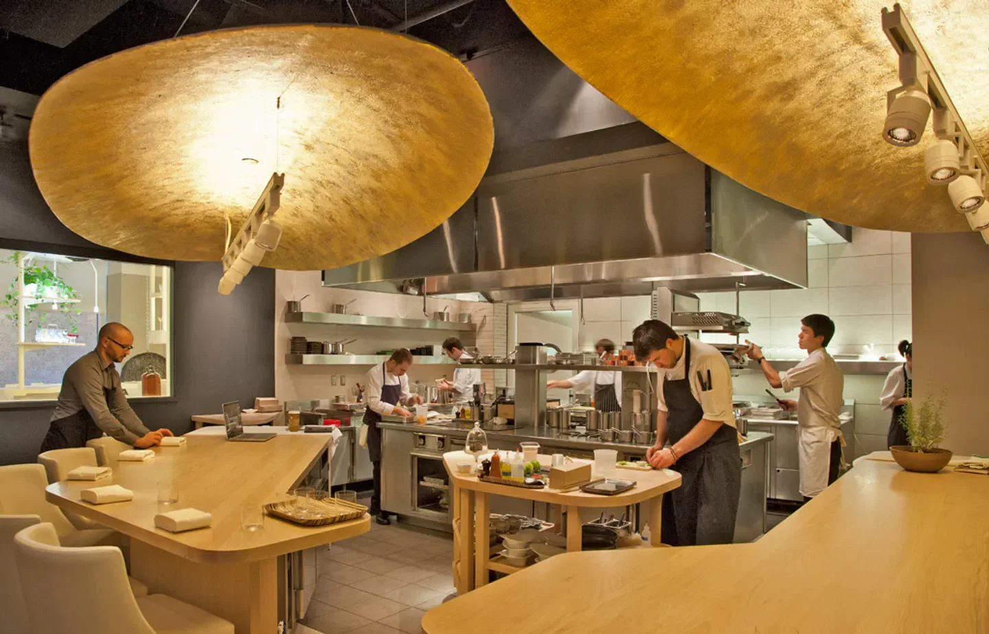 Chefs working in the kitchen at Minibar in Washington, preparing delicious dishes.