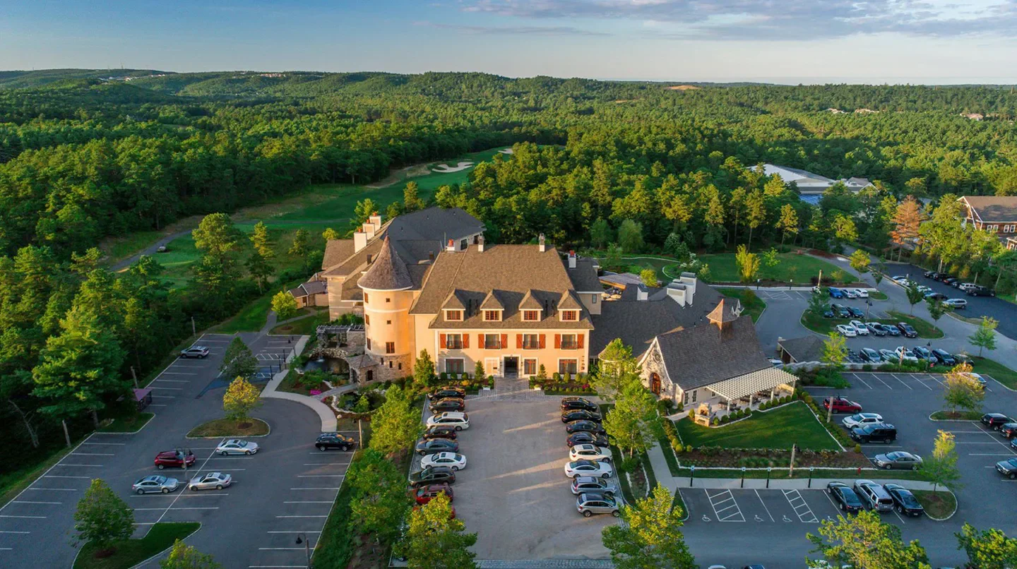 Aerial view of Mirbeau Inn & Spa Plymouth near Nantucket, surrounded by green landscape.