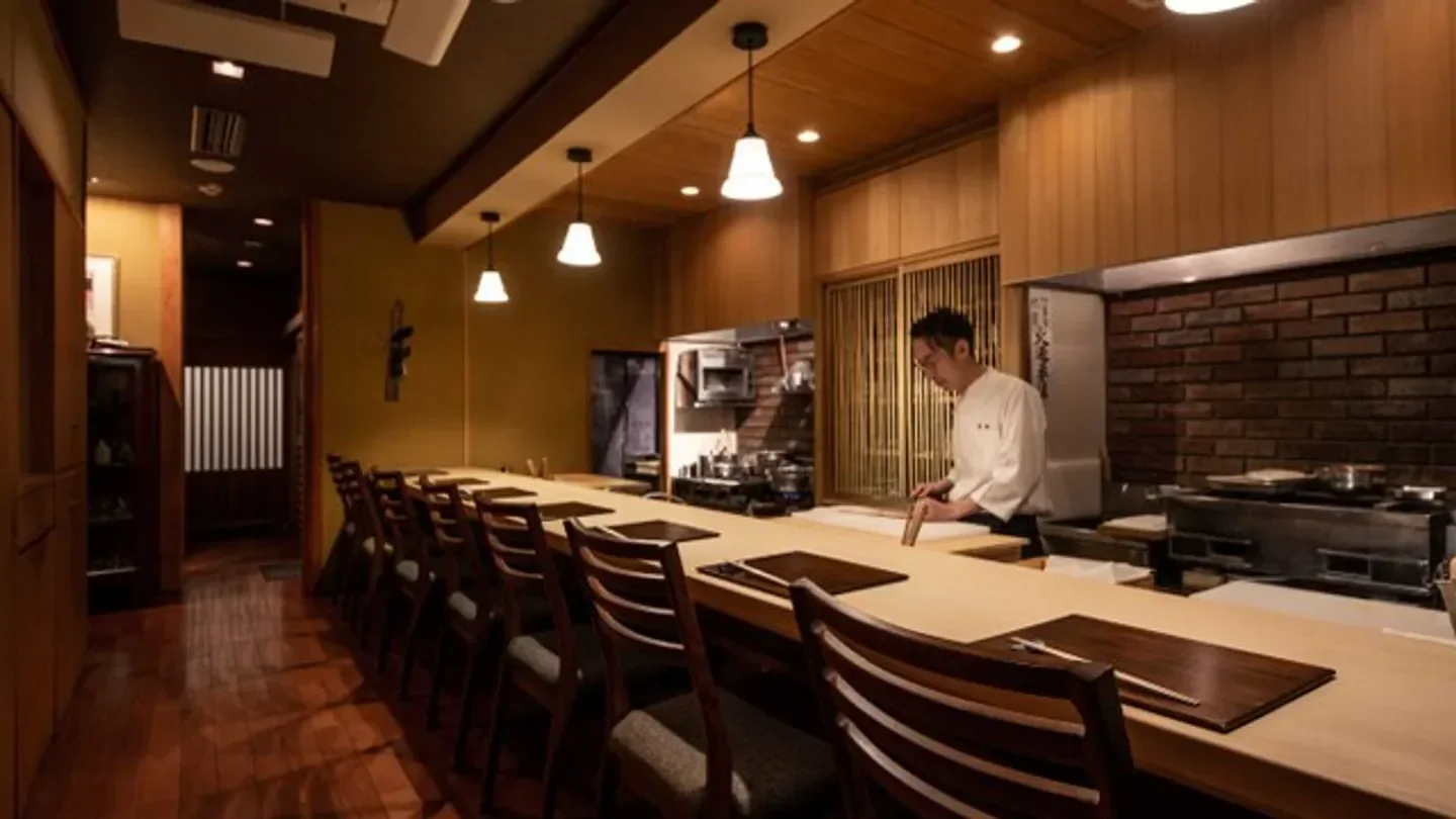 Interior of Mirei restaurant in Kyoto, with chef preparing food at the counter