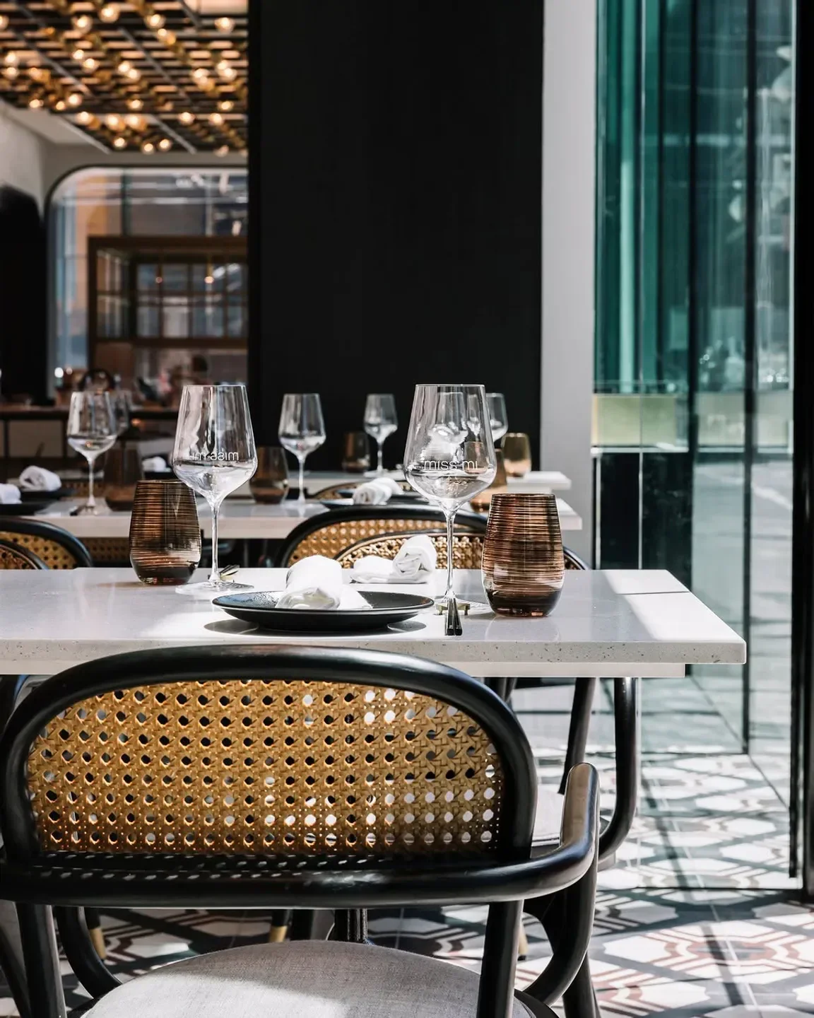 Elegant dining at Miss Mi restaurant in Melbourne, featuring stylish tables and chairs.