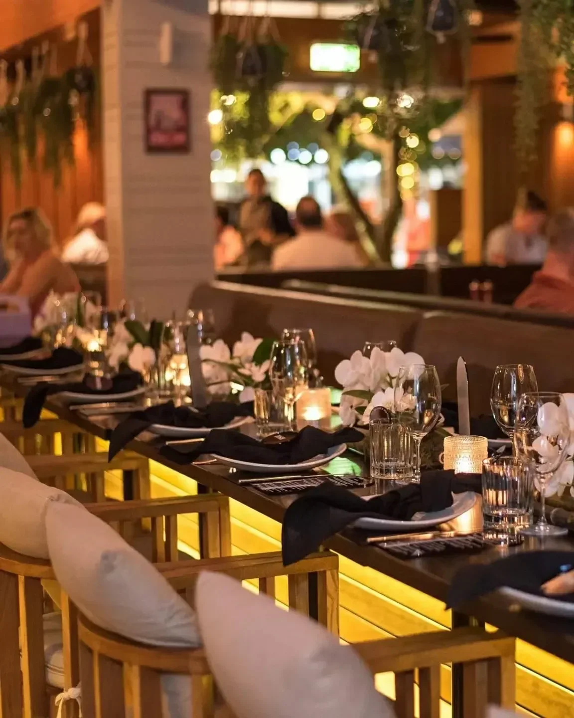 Elegant dining at Miss Moneypennys Noosa restaurant, Sunshine Coast with floral decor and candles.
