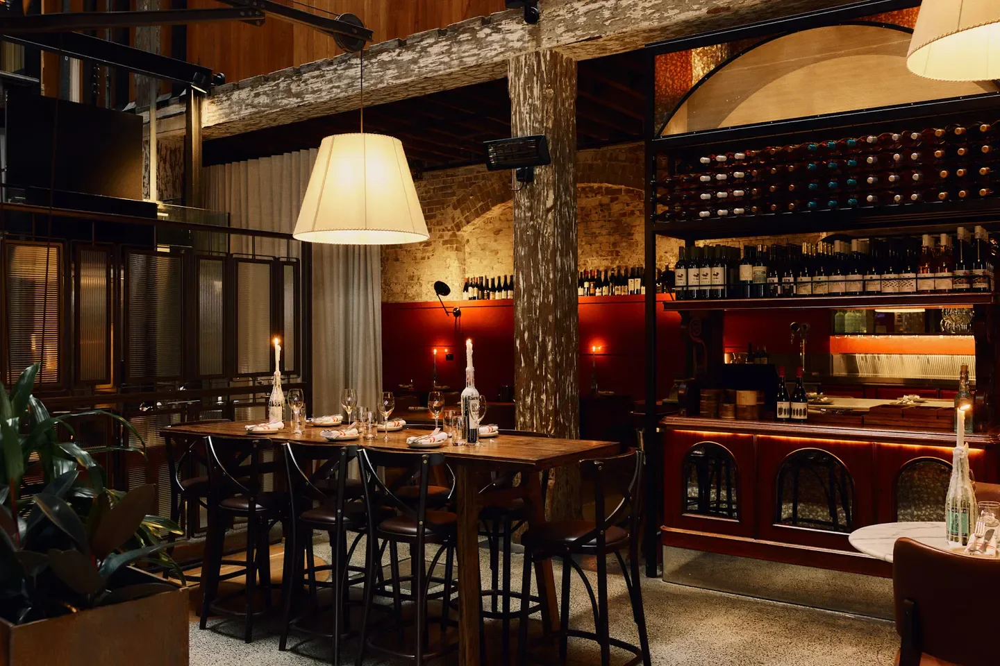 Cozy dining area at Mister Percy restaurant in Sydney, featuring candles and wine selection.