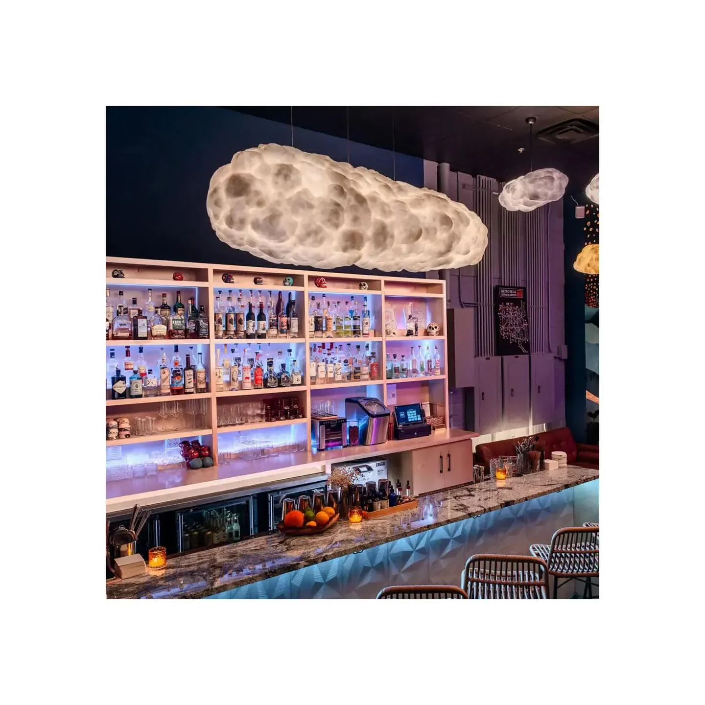 Cloud-shaped lights over the bar at Mixtli restaurant in San Antonio.