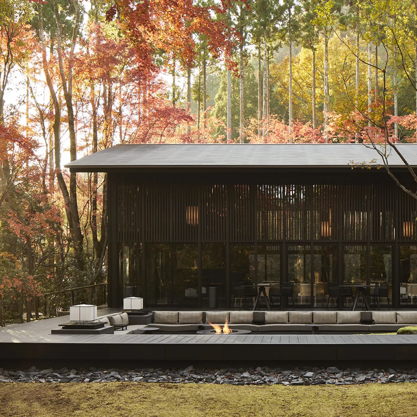 Outdoor seating area at Miyamaso restaurant in Kyoto, surrounded by autumn foliage.