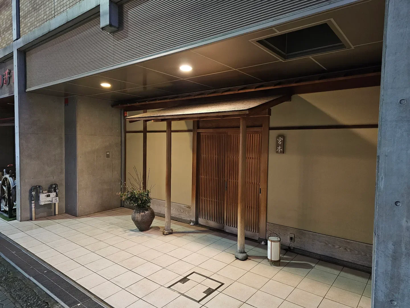 Entrance to Miyamoto restaurant in Osaka, Japan, featuring traditional wooden design.