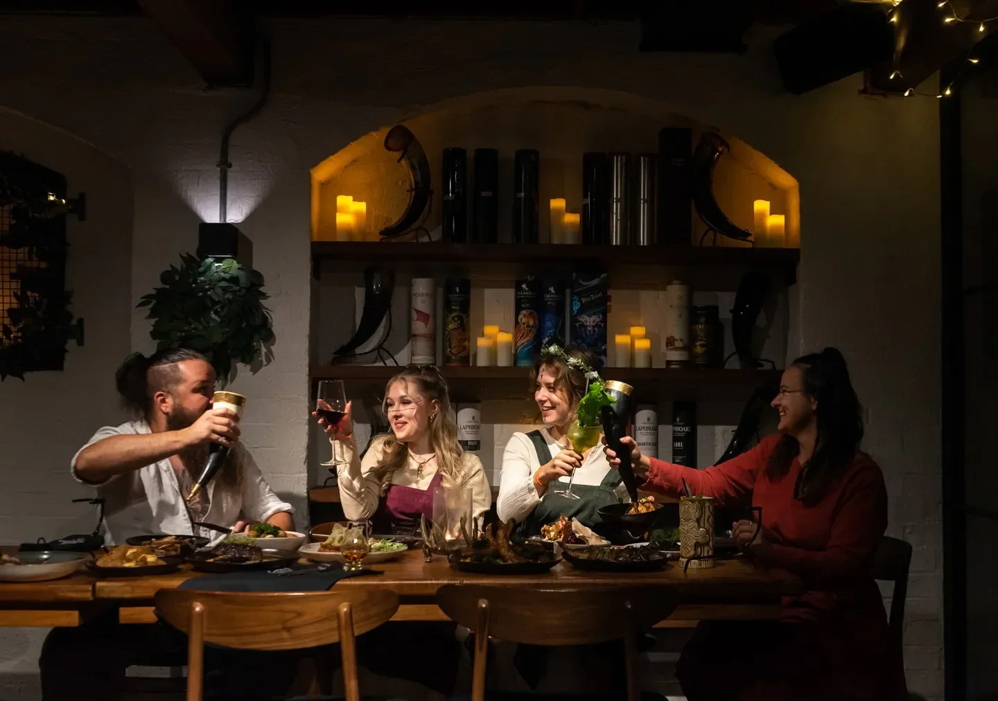 Group cheers at Mjølner Melbourne restaurant, enjoying drinks and a meal together.
