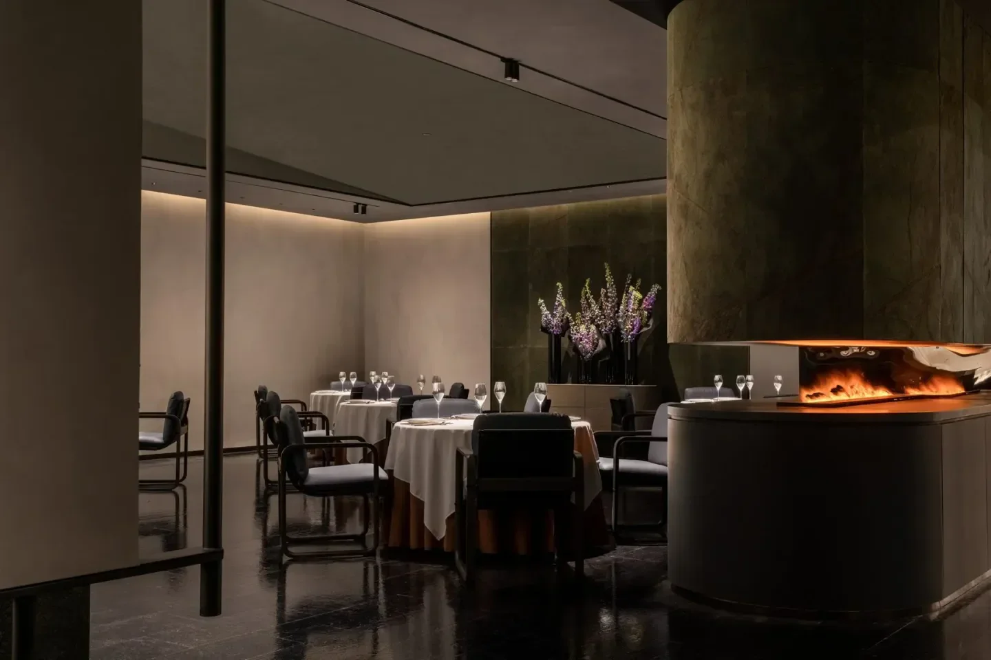 Elegant interior of MO Jasmine restaurant in Beijing with stylish dining area and fireplace.