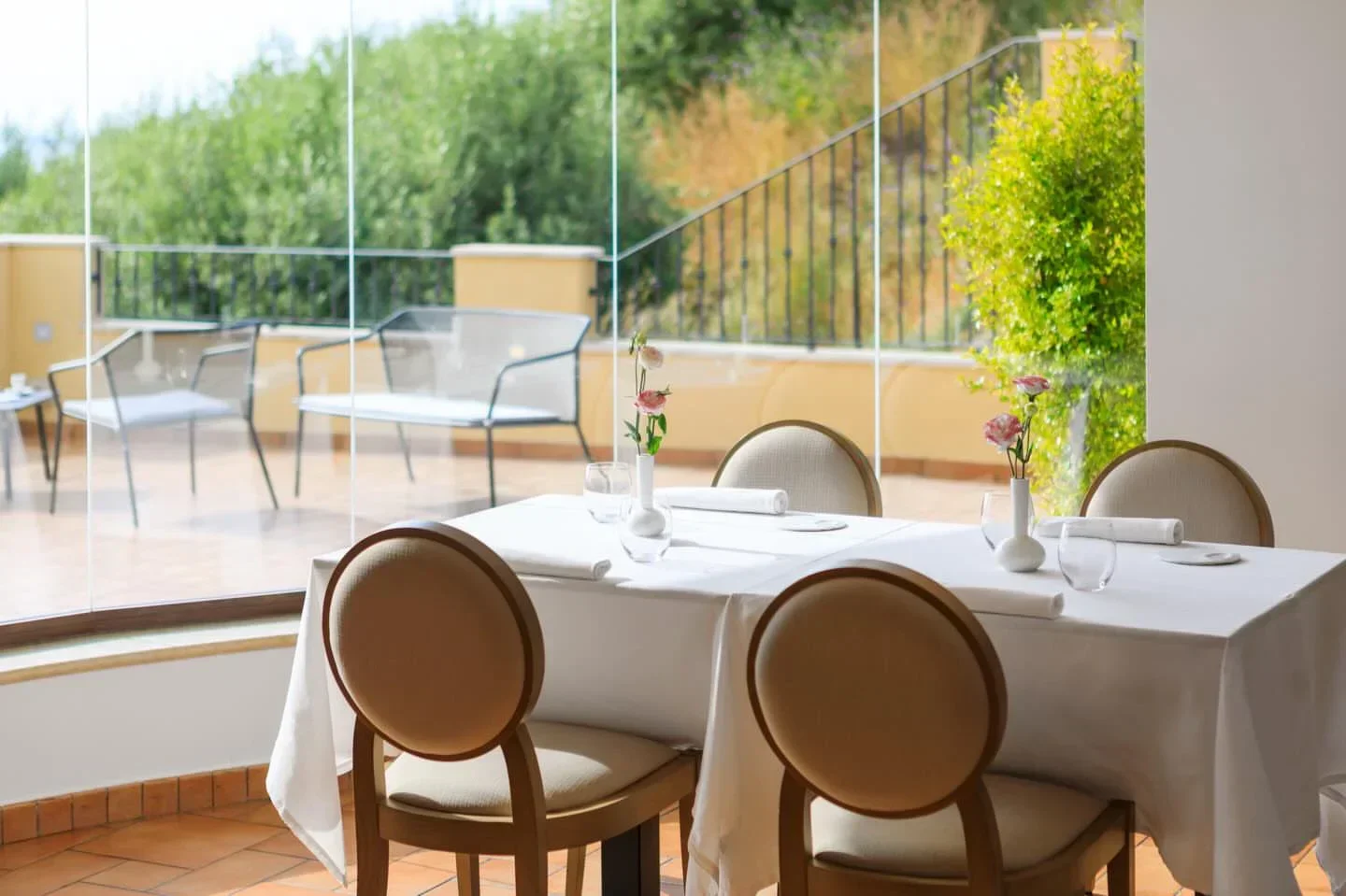 Elegant dining at Modì restaurant in Sicily, featuring a table setting with a view