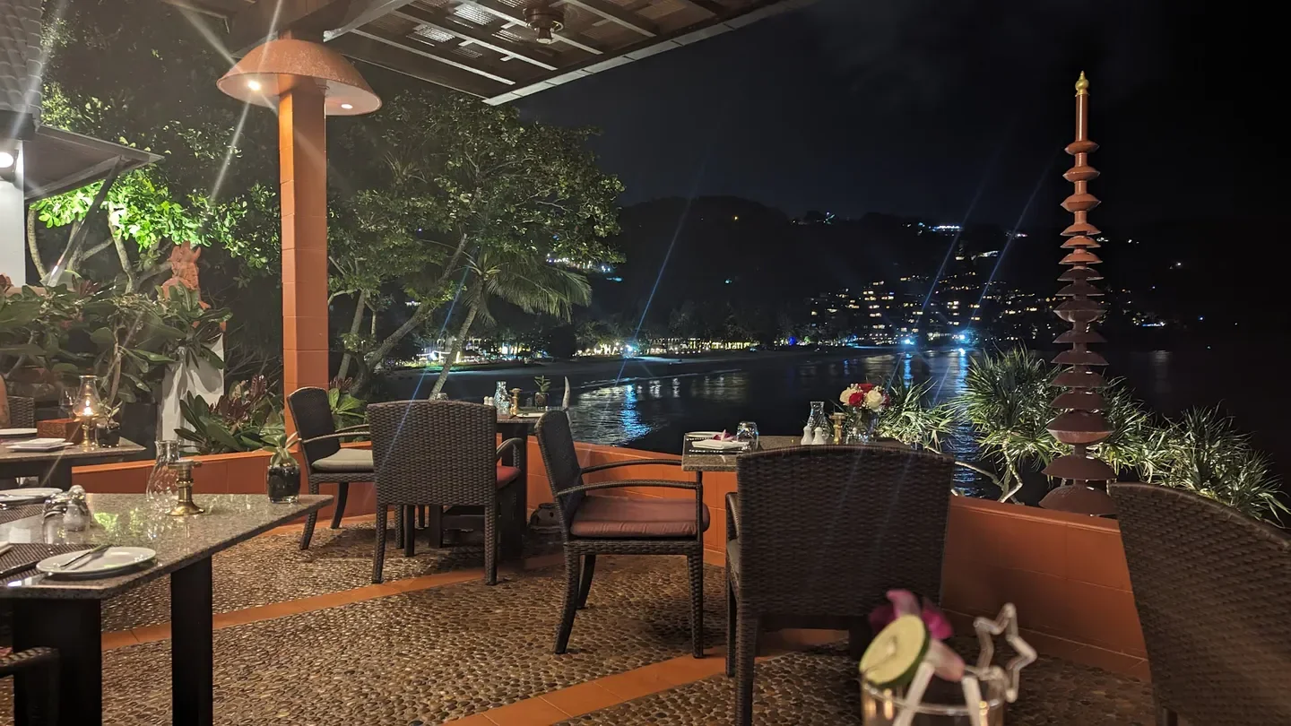 Mom Tri's Kitchen in Phuket: elegant beachfront dining at night, water views.