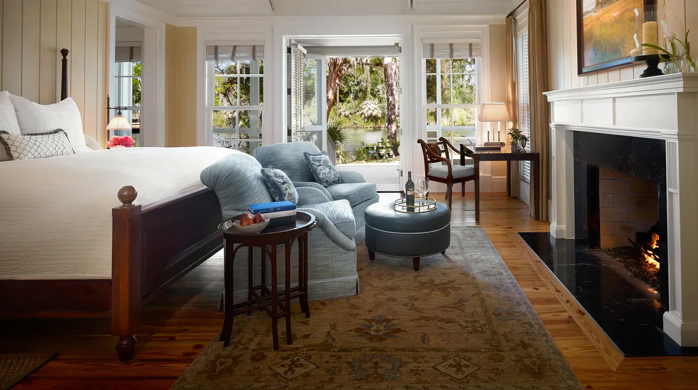 Cozy bedroom at Montage Palmetto Bluff in Hilton Head Island with fireplace and scenic views