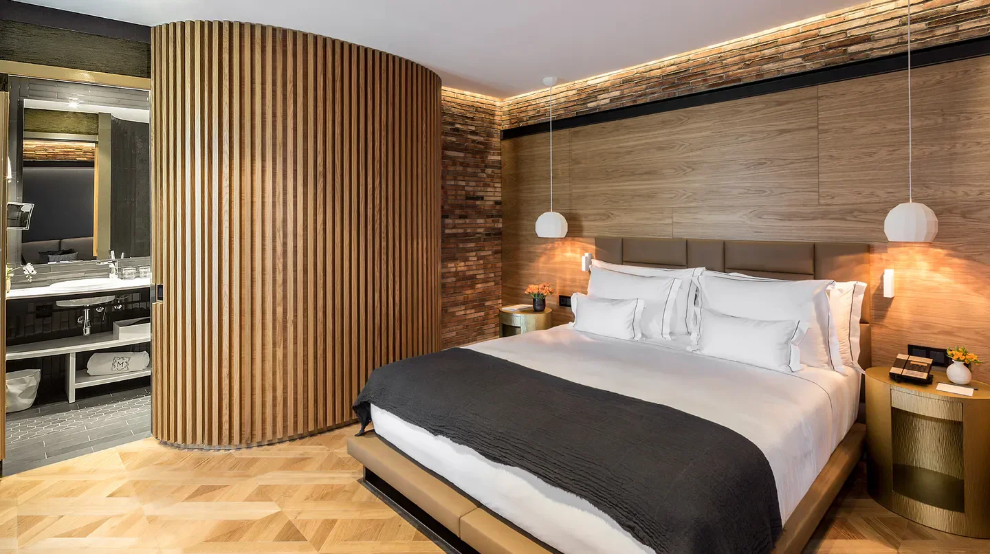 Cozy bedroom at Monument Hotel in Barcelona with a modern design and wooden accents.