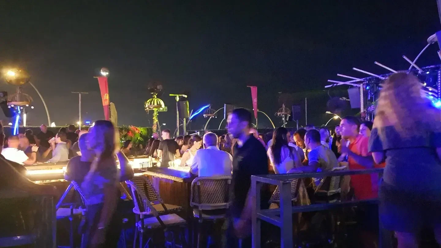 Nightclub scene at Moonchild in Tel Aviv, with people enjoying the bar.