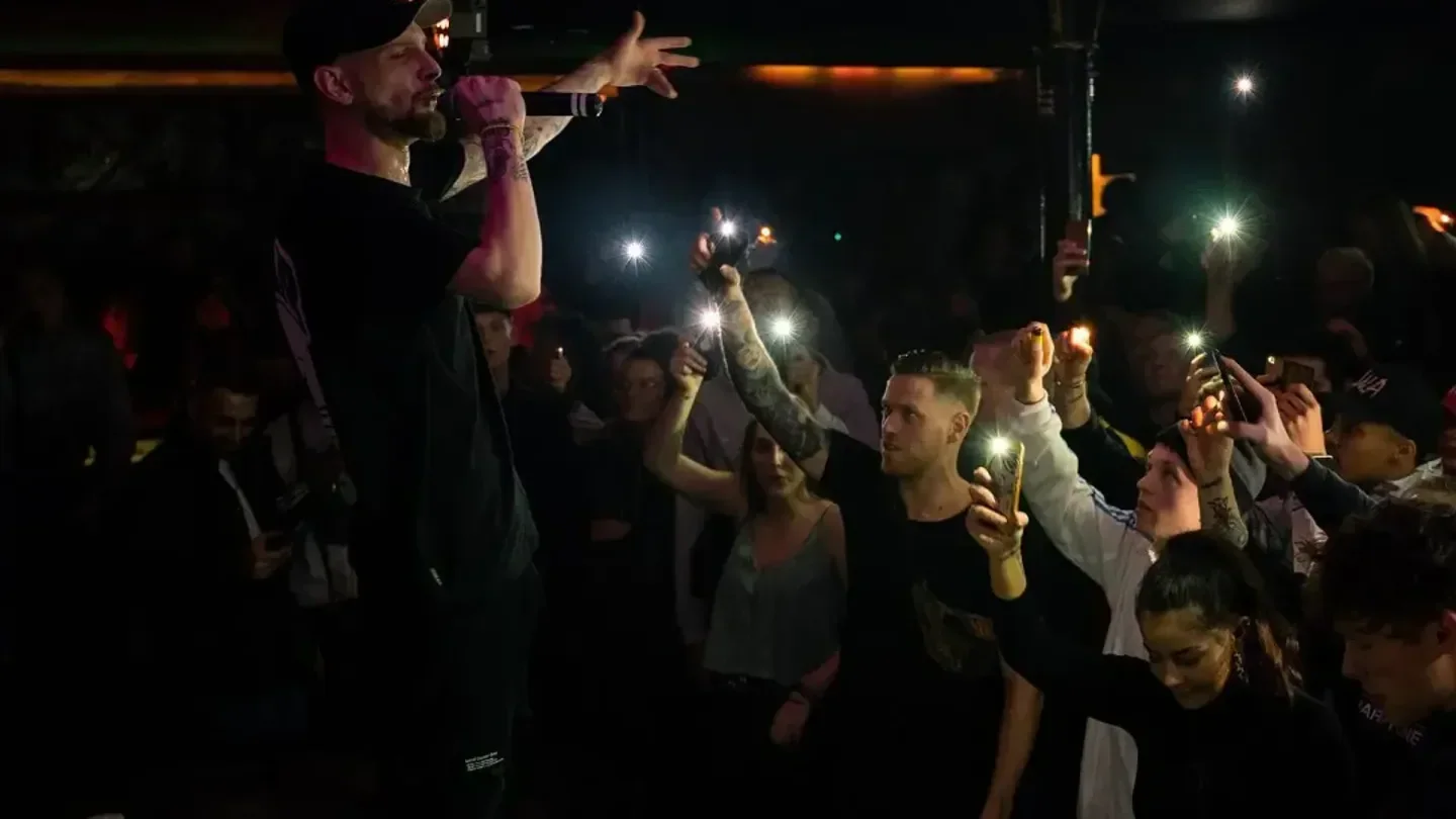 Concert at Moondoo nightclub in Hamburg, with crowd filming with their phones.