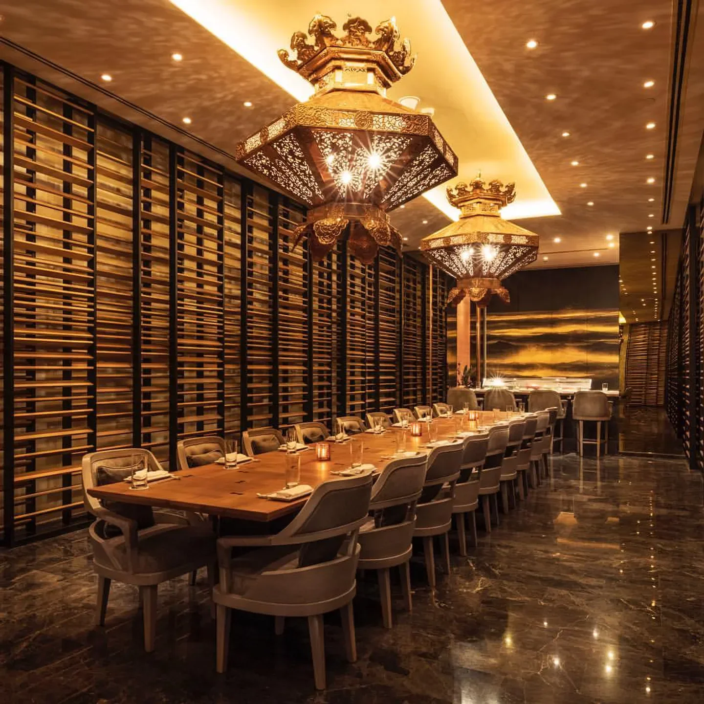 Elegant dining at Morimoto Doha, showcasing a long table and ornate lighting.