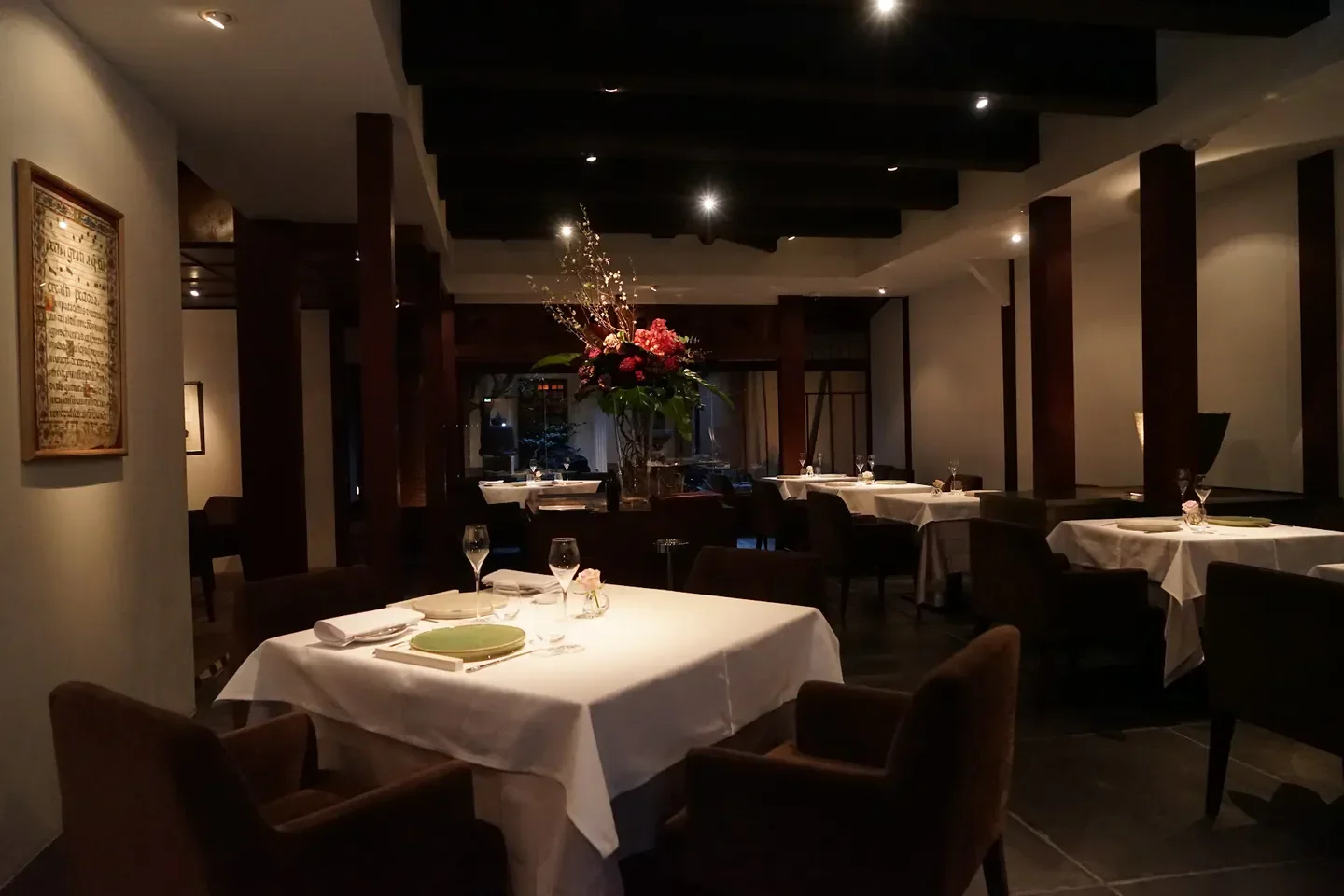 Elegant dining room interior at Motoï in Kyoto, featuring table settings and floral arrangements.
