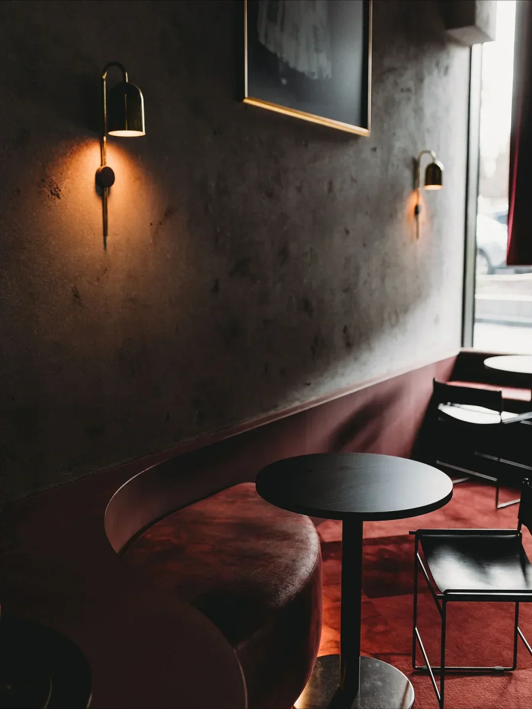 Cozy seating area at MU restaurant in Canberra, featuring a round table and warm lighting.