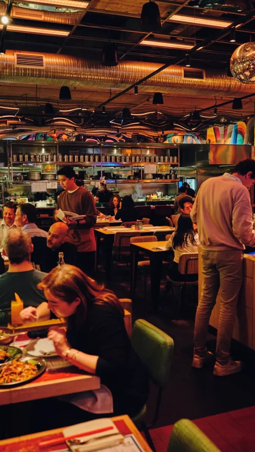 Inside MuMu restaurant in Sydney, Australia, featuring a busy dining room with people enjoying a meal.